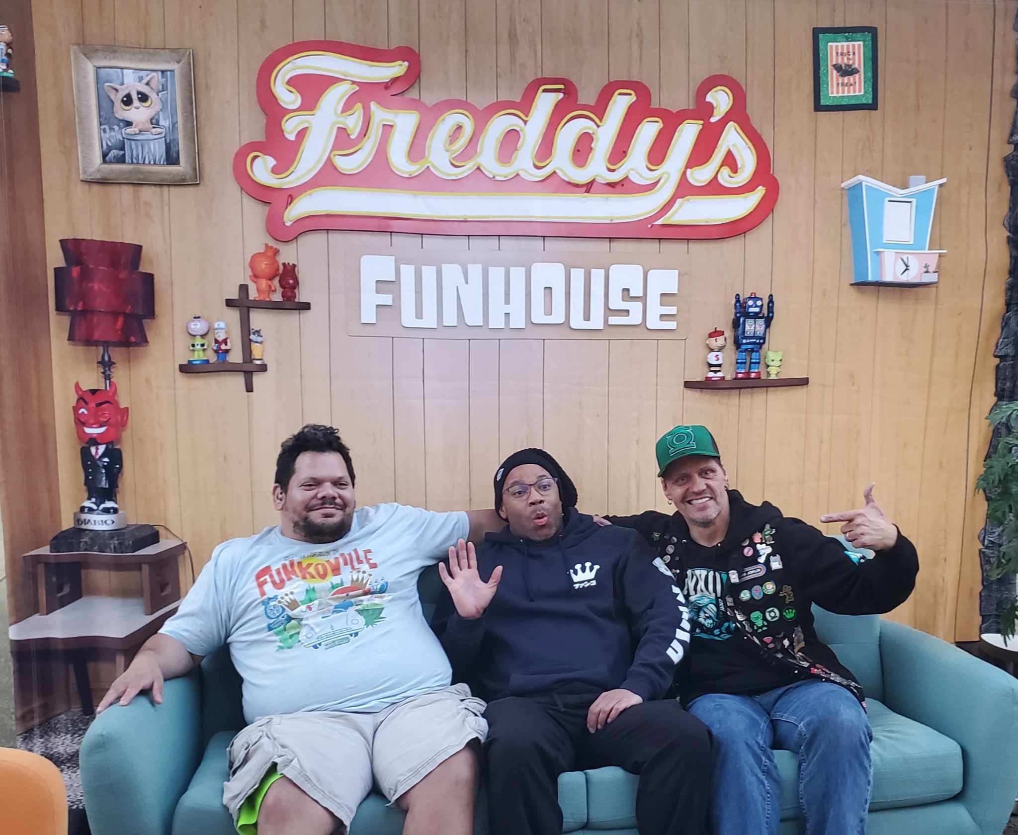 Long-time Funatics take a seat on a couch inside Freddy’s Funhouse. 